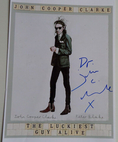 JOHN COOPER-CLARKE AUTOGRAPHED A4 PHOTOGRAPH.